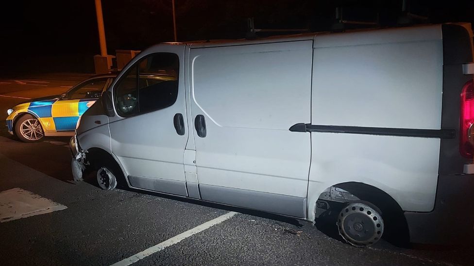 Van with two missing tyres