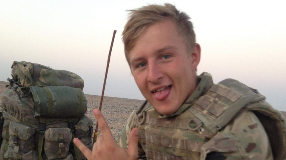 Craig Welsh pictured sticking his tongue out and wearing combat uniform
