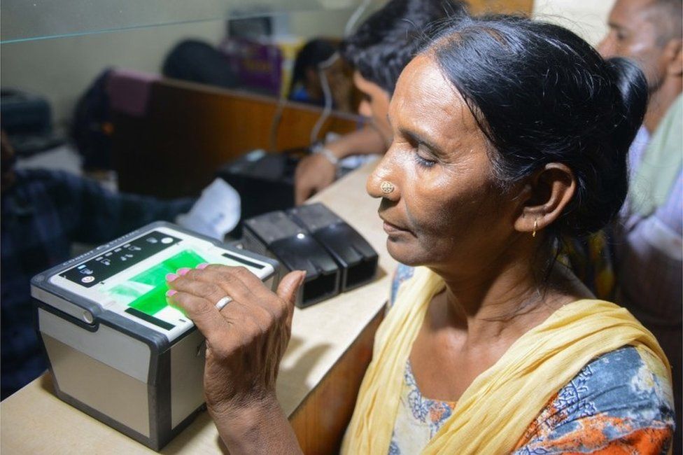 This photo taken on July 17, 2018 shows an Indian woman getting her fingerprints read during the registration process for Aadhaar cards (or unique identifier [UID] cards) in Amritsar