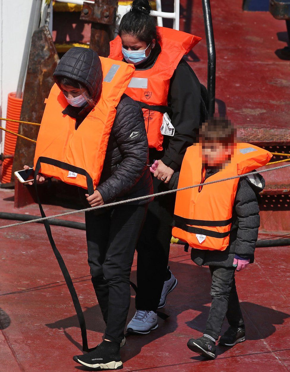 A group of migrants, including children, are brought to Dover on Thursday 3 June