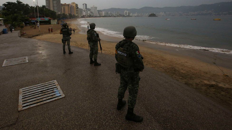 Soldiers keep watch at a beach as Hurricane Otis barrels towards Acapulco, Mexico