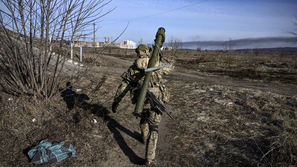 A Ukrainian serviceman walks towards the front line in Irpin last year