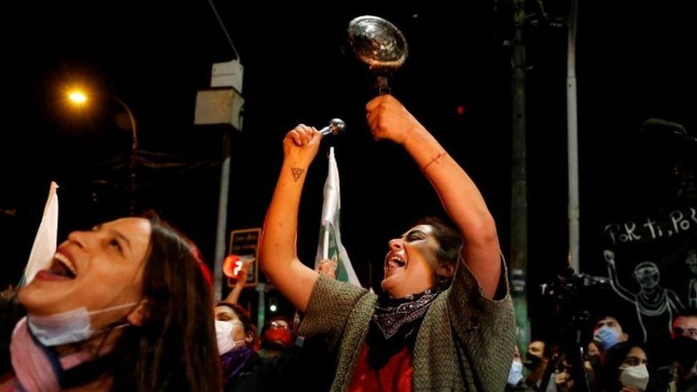 A woman bangs a pot as she reacts to the referendum on a new Chilean constitution in Valparaiso, Chile, October 25, 2020