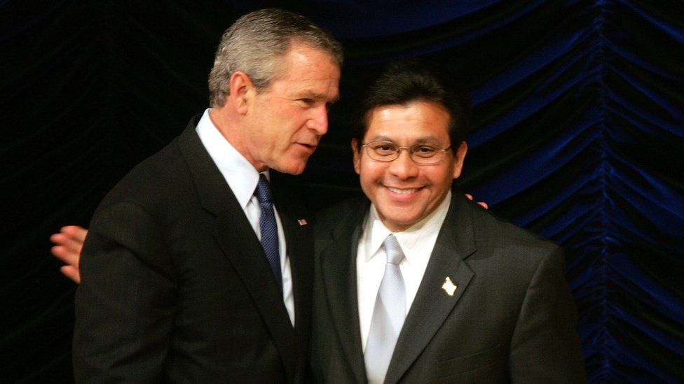 Former US President George W Bush embraces former US Attorney General Alberto Gonzales, 20 April 2005