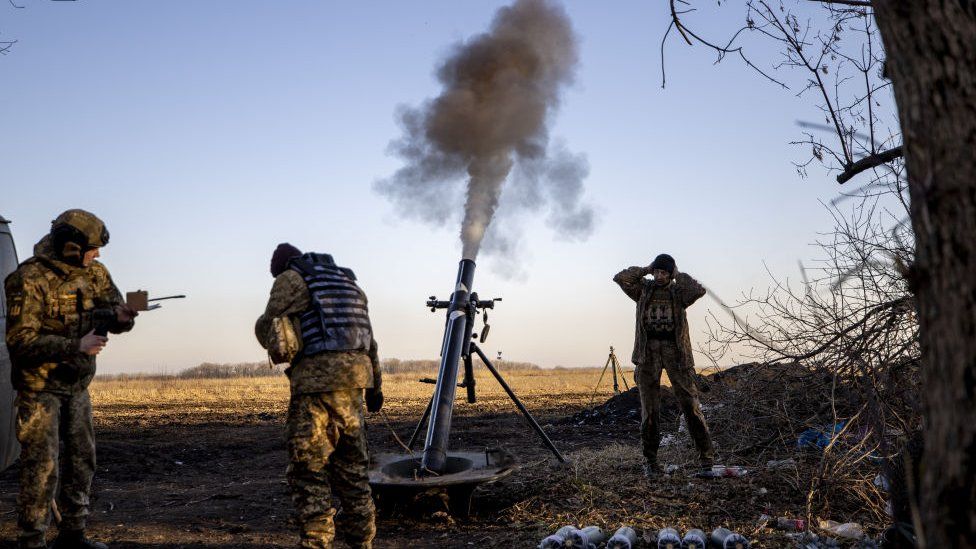 Ukrainian forces fire a mortar in the Donbas