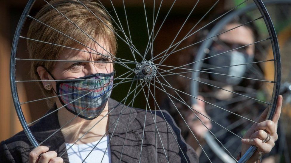 Nicola Sturgeon holds a bicycle wheel