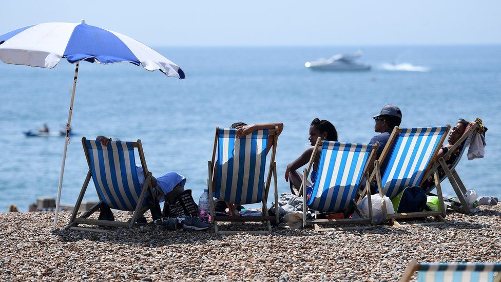 People enjoying the hot weather on Brighton beach in July 2018