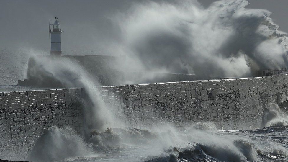 Waves crashing against the sea wall in Newhaven during Storm Isha
