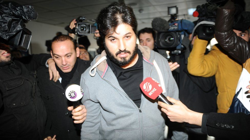 Detained Azerbaijani businessman Reza Zarrab is surrounded by journalists as he arrives at a police centre in Istanbul on 17 December 2013
