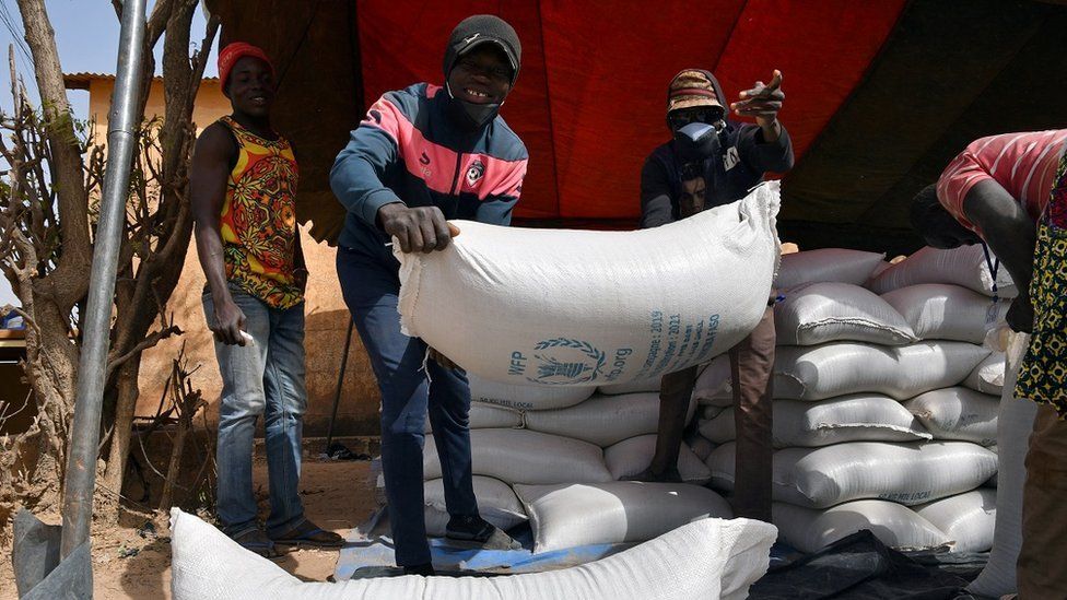 Workers carry the aid provided by the World Food Programme (WFP) for distribution in Pissila, Burkina Faso January 24, 2020
