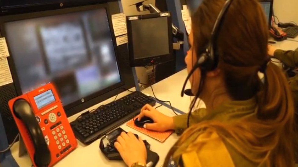 An Israel Defense Forces field observer looks at a monitor inside a "war room" near Israel's northern border with Lebanon