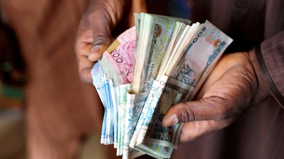 A man counts Nigerian naira notes in a market place in Yola, Nigeria, February 22, 2023.