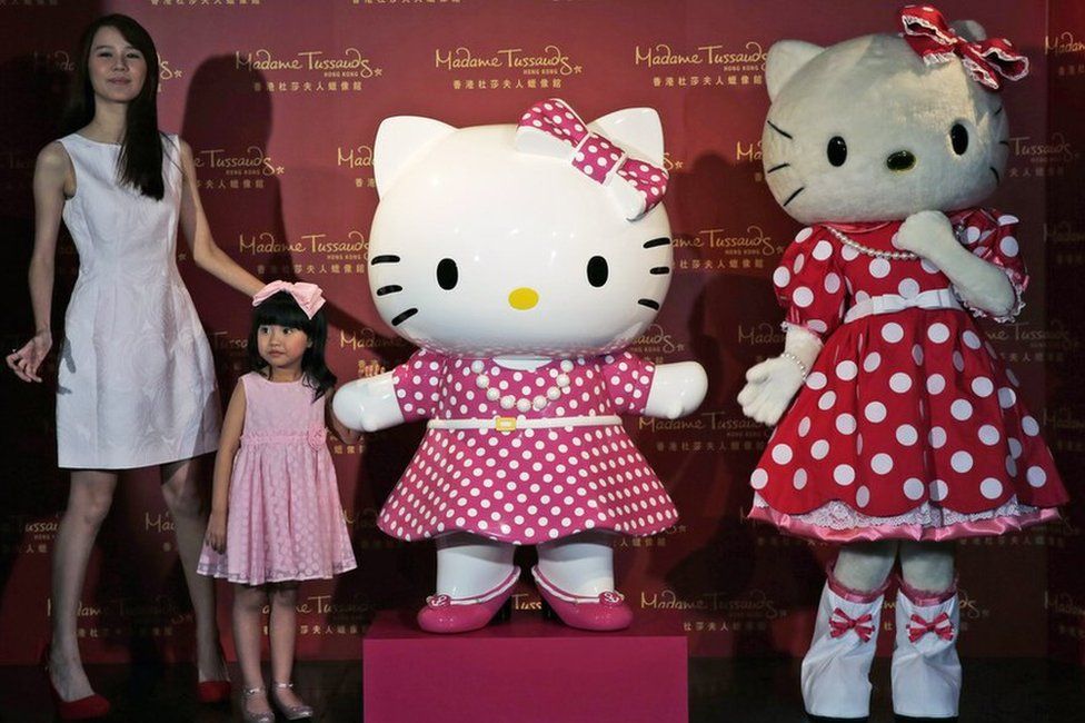 In this 24 July 2014 file photo, a model dressing as Japanese character Hello Kitty, right, along with Hong Kong actresses Priscilla Wong, left, and Celine Yeung, second from left, pose with a new figure of Hello Kitty unveiled at the Madame Tussauds in Hong Kong, to mark the 40th anniversary of the birth of the popular Sanrio character.