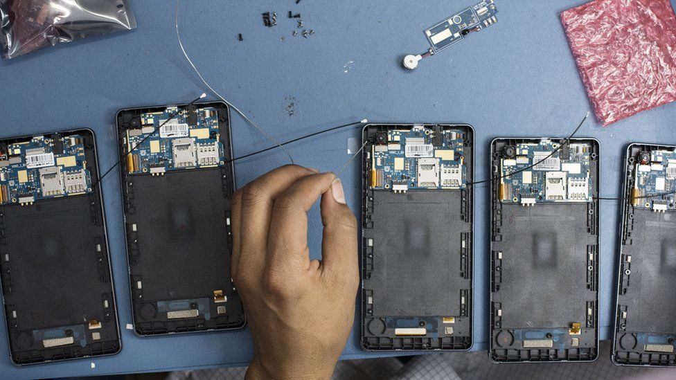 Technicians assemble smartphones