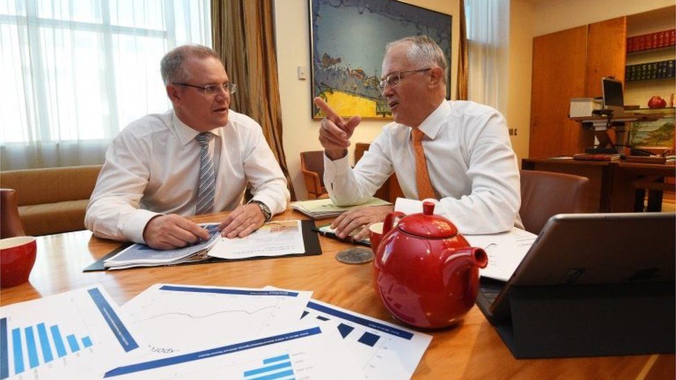 Australian Treasurer Scott Morrison (L) and Prime Minister Malcolm Turnbull look at Budget Papers during their meeting at Parliament House in Canberra, Australia, 02 May 2016