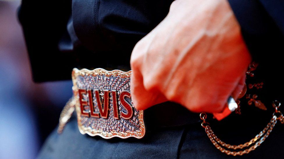Baz Luhrmann showing his Elvis belt at the Cannes Film Festival