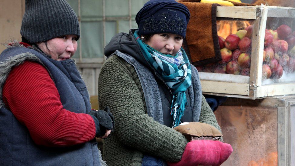 Kyrgyz women trade in the cold at a bazaar in Bishkek, Kyrgyzstan
