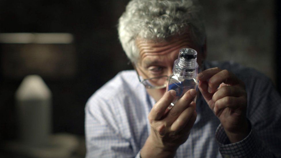 Grigory Rodchenkov examining a tamper-proof urine sample bottle in the documentary, Icarus