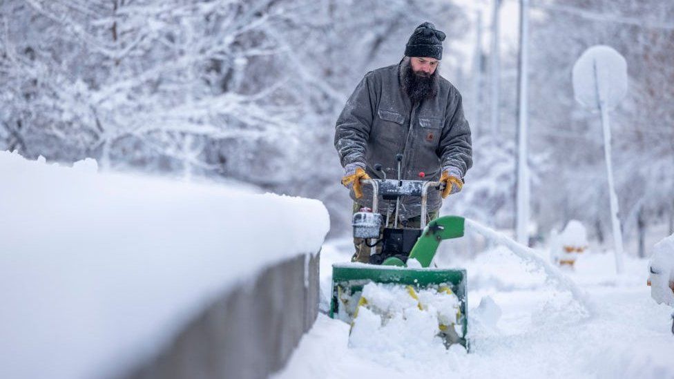 Residents plow snow during a storm in Des Moines, Iowa, US, on Tuesday, Jan. 9, 2024.