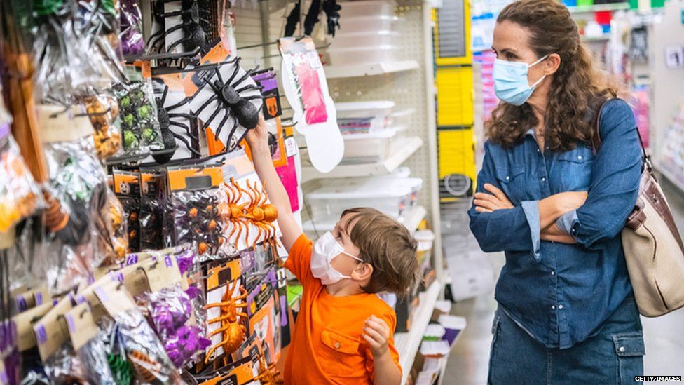 Woman and child shopping for Halloween gifts