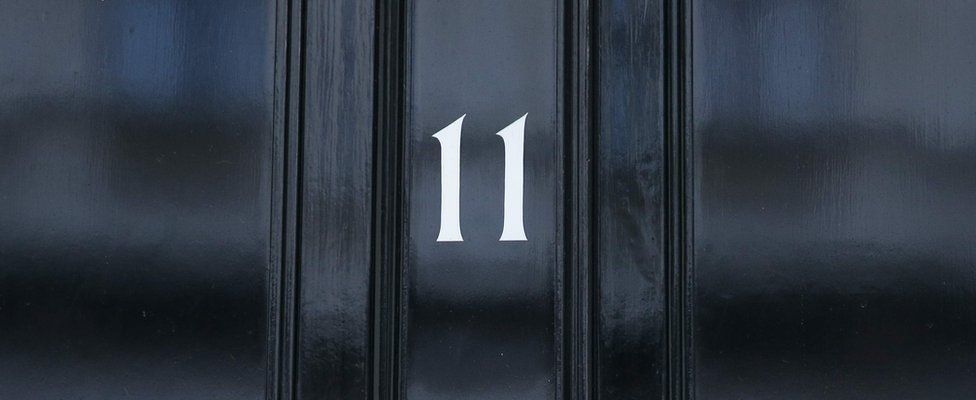 Image shows the front door of 11 Downing Street, the official residence of the Chancellor of the Exchequer