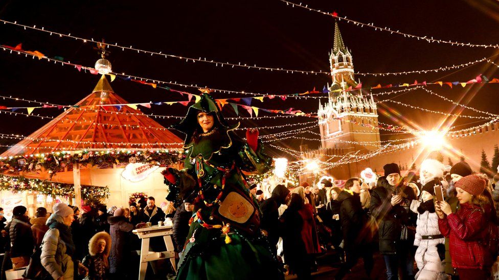A woman wearing a costume at the illuminated street ahead of Christmas in Moscow