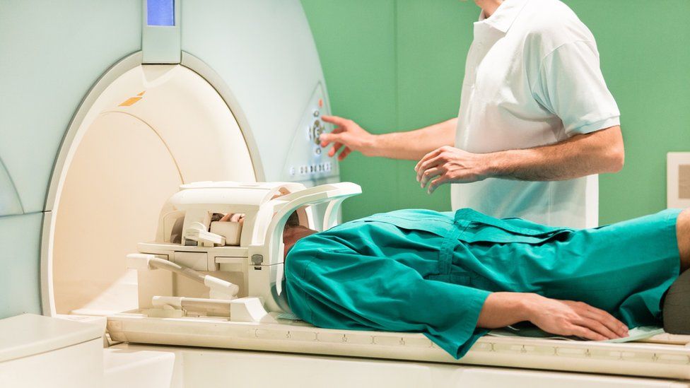 Doctor and patient using MRI scanner