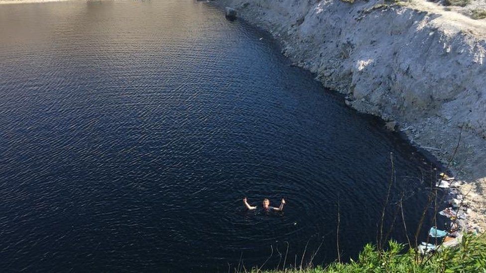 Person in quarry pool