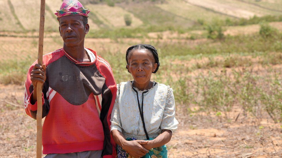 A woman and an man standing in a field