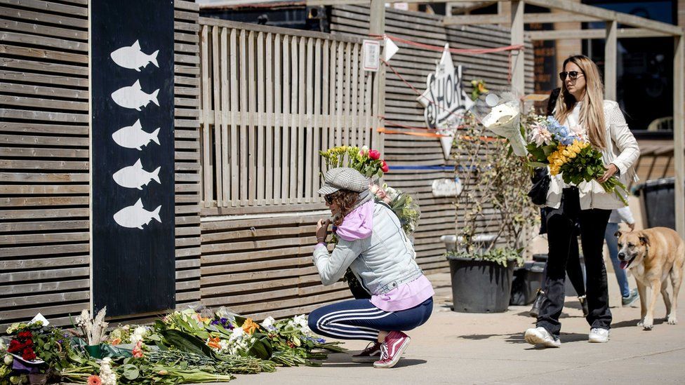 People lay flowers at surf club The Shore in Scheveningen, The Netherlands, 12 April 2020