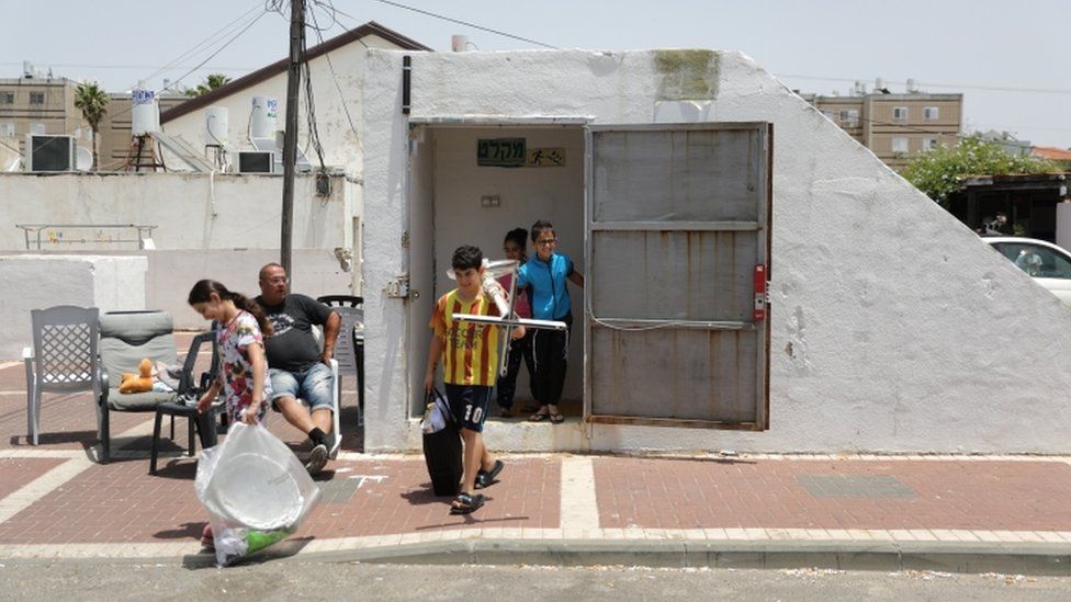 Israelis come out of the bomb shelter at the city of Ashkelon