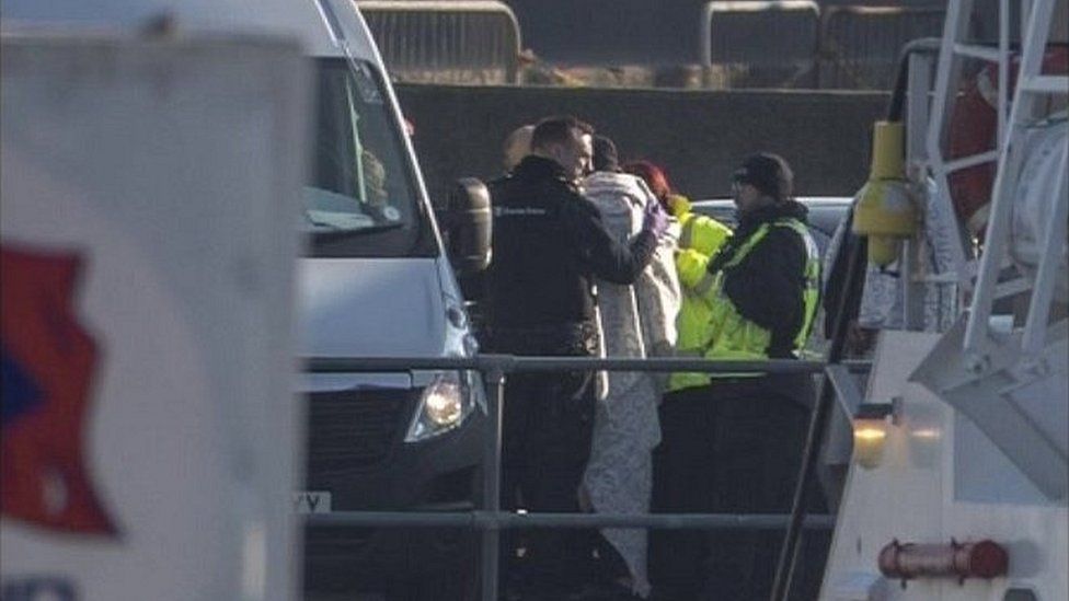Border Force officers with migrants at Dover
