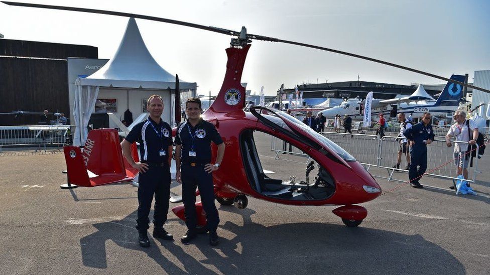 French railway (SNCF) personnel stand by an Auto Gyro Gyroplane inspection unit aircraft used by the SNCF to monitor railways, at the International Paris Air Show in Le Bourget outside Paris on June 21, 2017