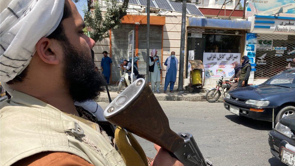 A Taliban fighter directing traffic in Kabul