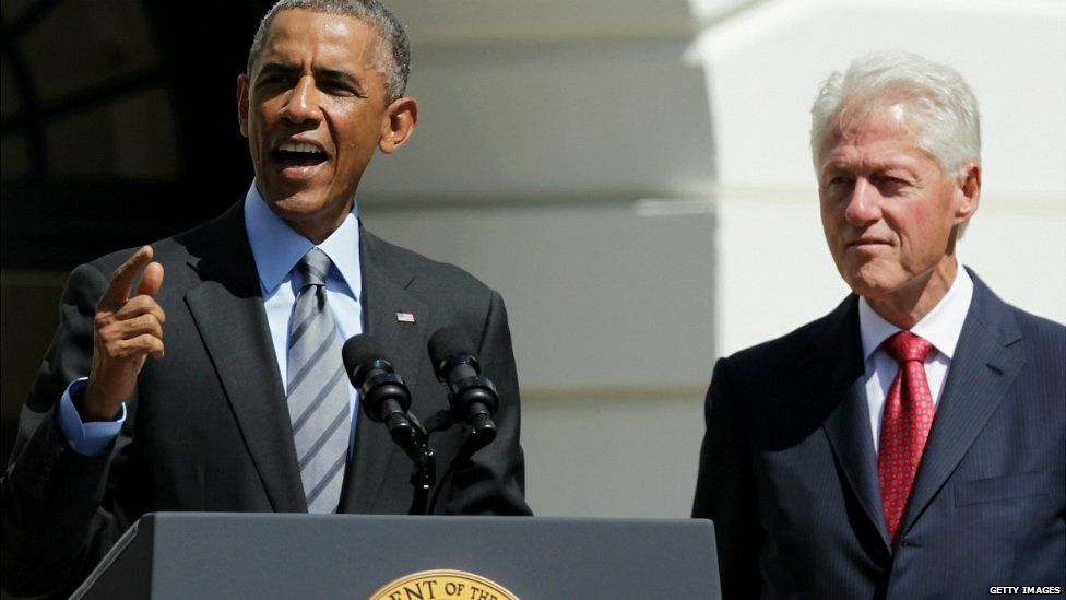 US President Barack Obama speaks as former President Bill Clinton listens at the White House in Washington DC - 12 September 2014