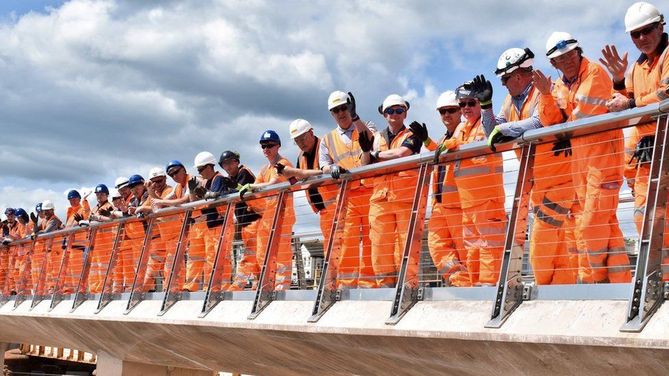 Workers at the finished sea wall site