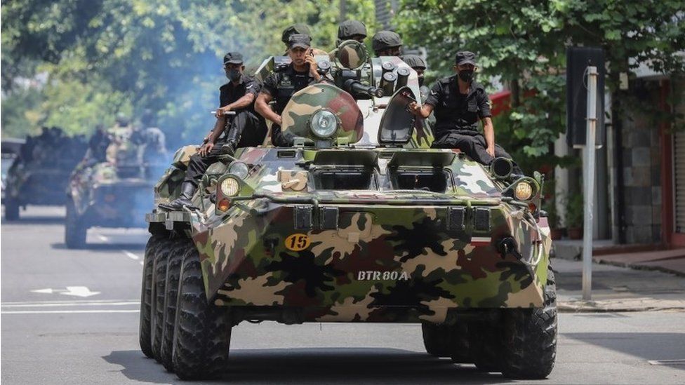 Armed military personnel patrol during an island-wide curfew amid political unrest in Colombo, Sri Lanka, 11 May 2022.