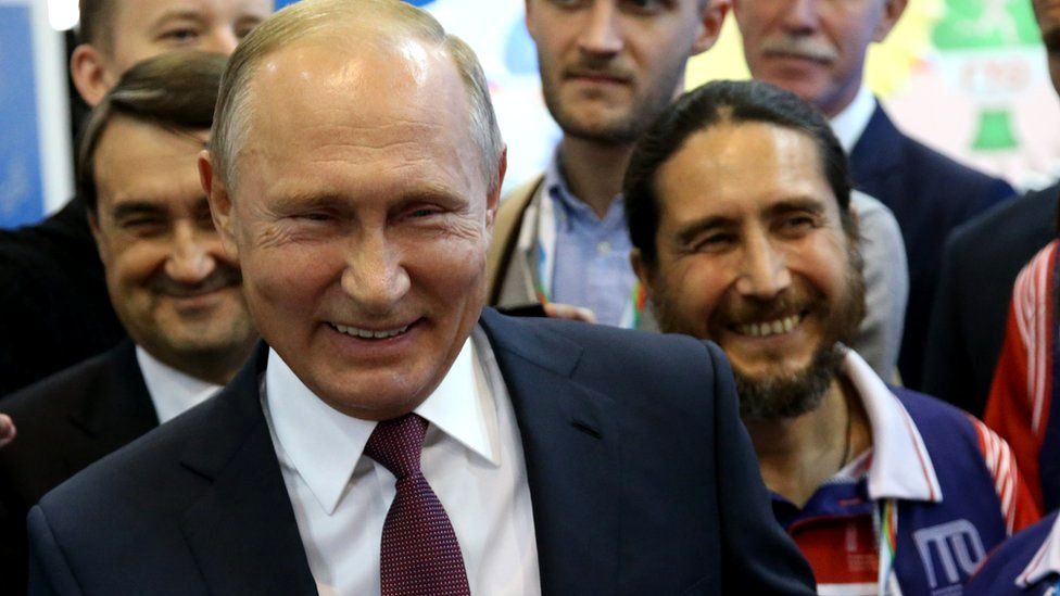 Russian President Vladimir Putin smiles during his meeting with athletes at the Russia in October 2018