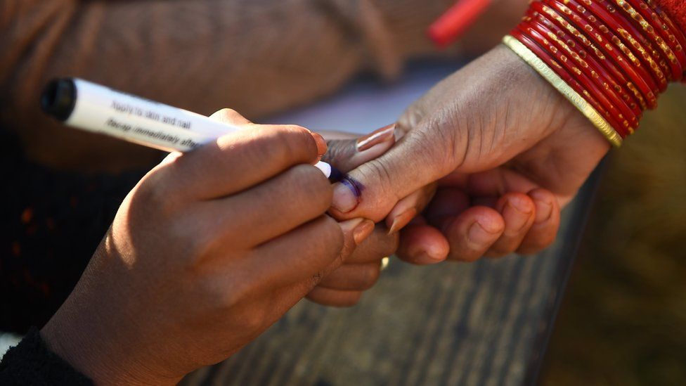 A Nepali election official marks a voter's finger with indelible ink at a polling station during the general election at Chautara, Sindhupalchowk district some 100km (60 miles) east of Kathmandu on 26 November 2017