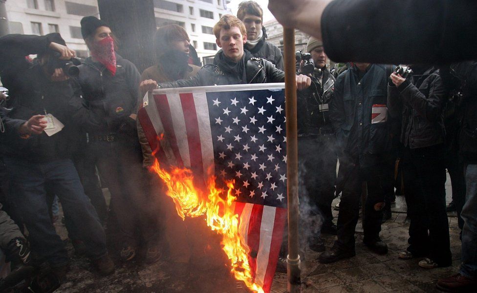 Anarchists burn an American flag [Stars and Stripes] after U.S. President George W. Bush's second term inauguration parade January 20, 2005 in Washington, D.C