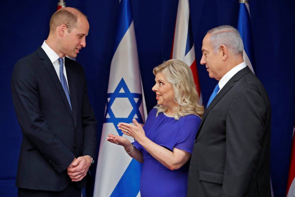 Prince William speaks with Israeli Prime Minister Benjamin Netanyahu and his wife Sara during a meeting at the Prime Minister's residence in Jerusalem