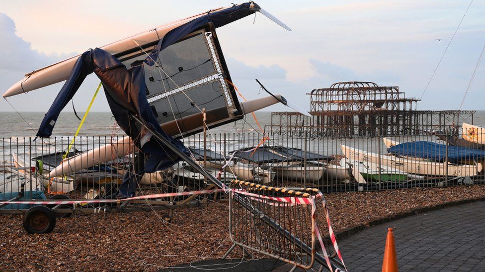 A catamaran lies upended in Brighton after Storm Eunice