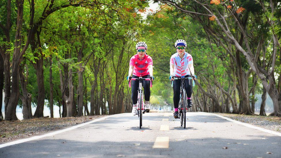 Two women cycling on road bikes