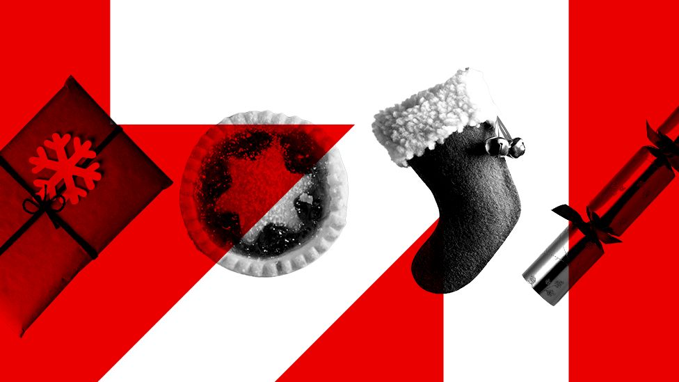 A photo of a mince pie, a decoration, a Christmas cracker and Christmas stocking on a red and white background