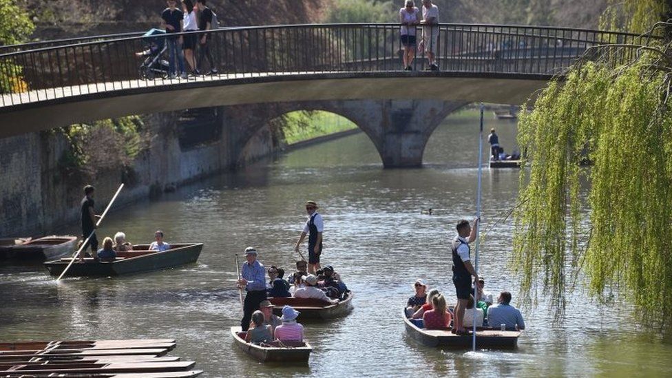 People punt along the River Cam in Cambridge