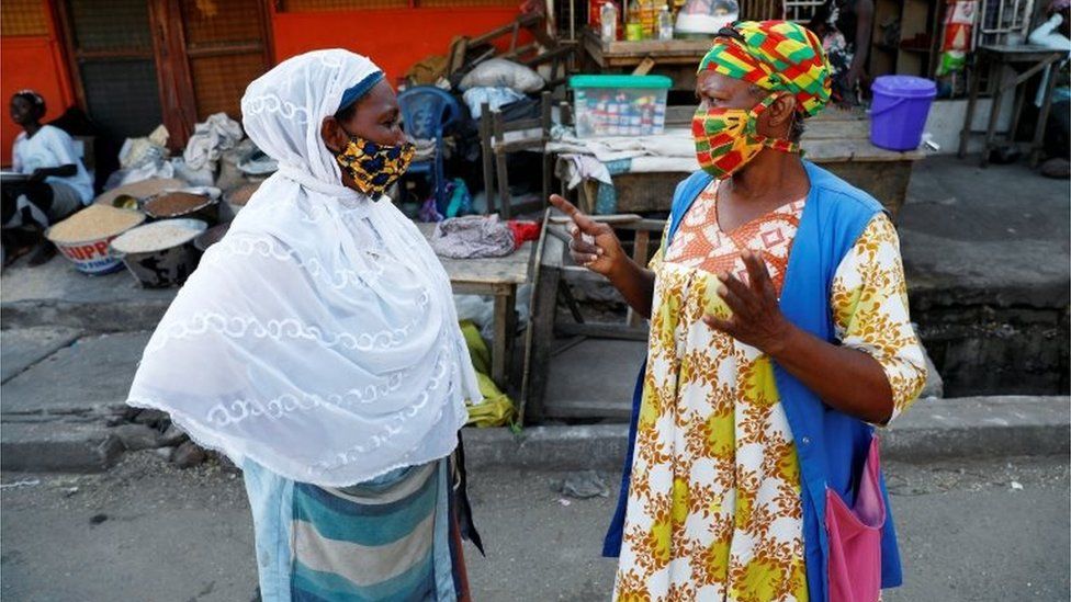Women wearing face masks chat at the Nima market as Ghana lifts partial lockdown amid the spread of the coronavirus disease (COVID-19), in Accra, Ghana April 20, 202