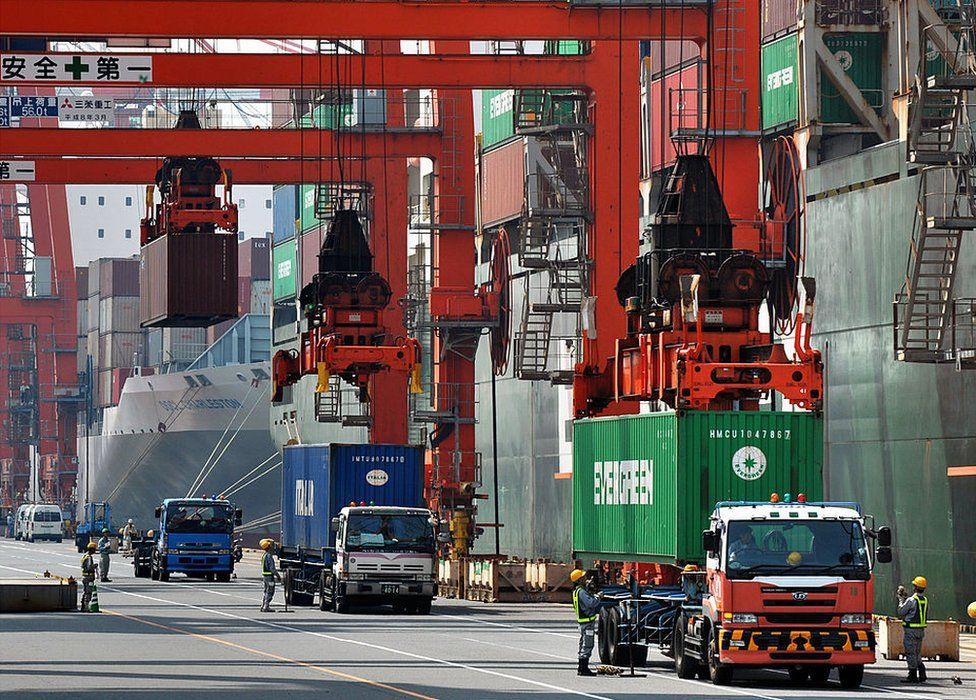 A cargo crane unloads containers from a ship at a quay in Tokyo in July 2012.