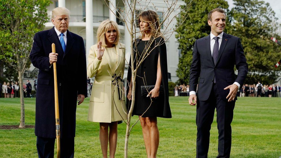 President Donald Trump, Brigitte Macron, Melania Trump and President Emmanuel Macron stand with the tree