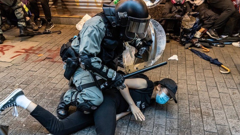Riot police arresting a Hong Kong protestor
