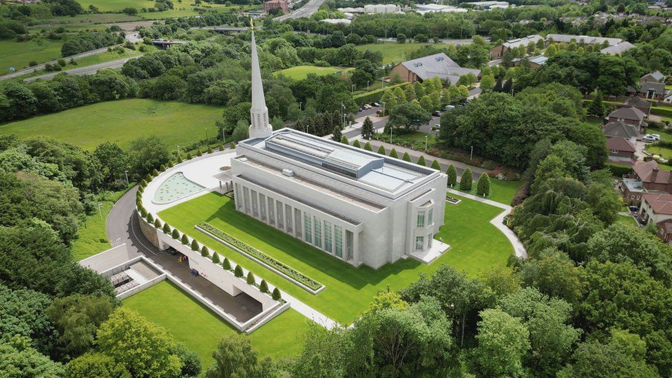 Mormon temple in Chorley - a large white building with a thin, tall spire surrounded by well-kept grounds